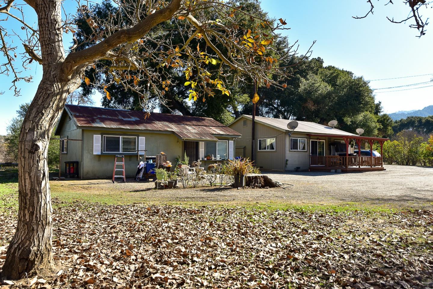 3385 Hecker Pass Road Gilroy, CA 95020 - Photo 18 of 18 a front view of a house with a big yard and large trees