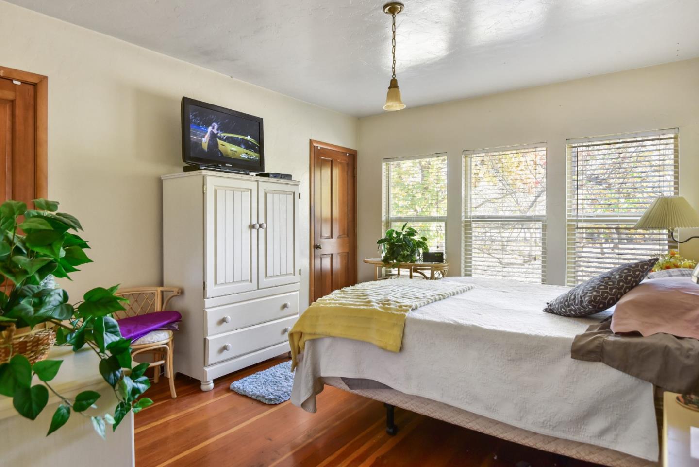 3385 Hecker Pass Road Gilroy, CA 95020 - Photo 6 of 18 a bedroom with a bed and a potted plant