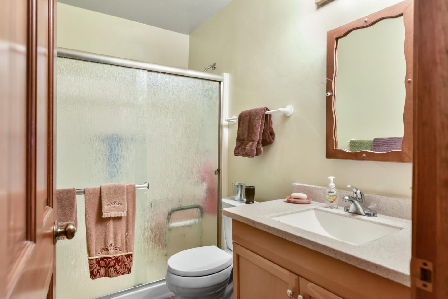 3385 Hecker Pass Road Gilroy, CA 95020 - Photo 8 of 18 a bathroom with a granite countertop sink toilet a mirror and shower