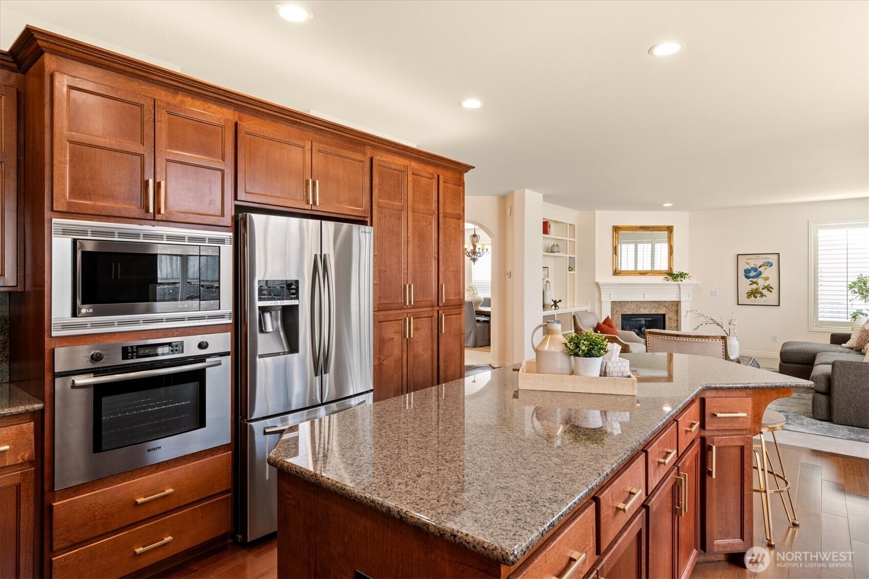 1206 South 36th Place Renton, WA 98055 - Photo 15 of 37 a kitchen with stainless steel appliances granite countertop a refrigerator a stove and a sink with wooden floor