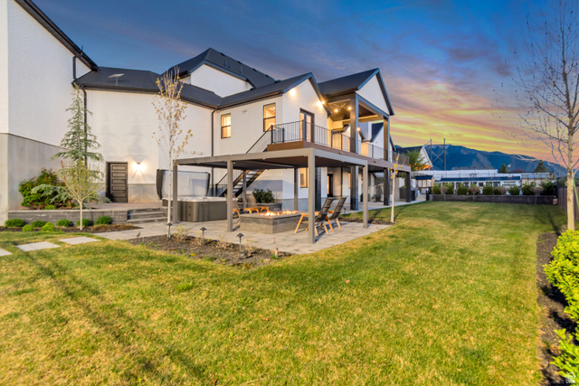 1720 Hillcrest Circle Mapleton, UT 84664 - Photo 18 of 116 Back of property at dusk featuring a patio, a mountain view, a hot tub, and a balcony