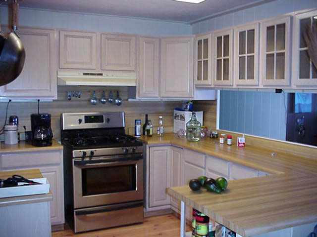 68 Maukanani Road Kula, HI 96790 - Photo 4 of 8 a kitchen with stainless steel appliances granite countertop a stove a sink and a white cabinets
