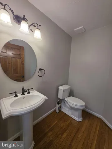 a bathroom with a sink a toilet and mirror