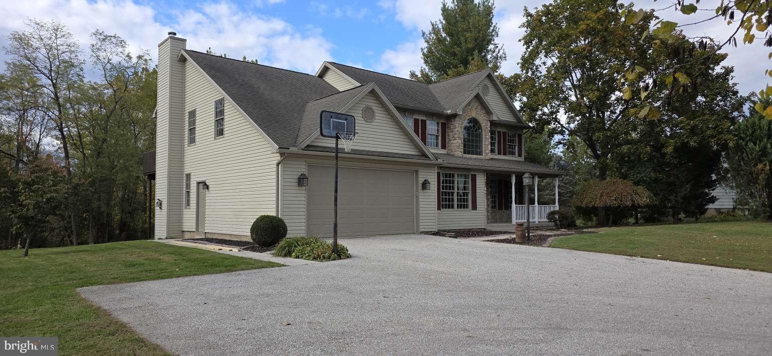 798 Menges Mills Road Spring Grove, PA 17362 - Photo 2 of 50 a view of a white house with a yard and plants