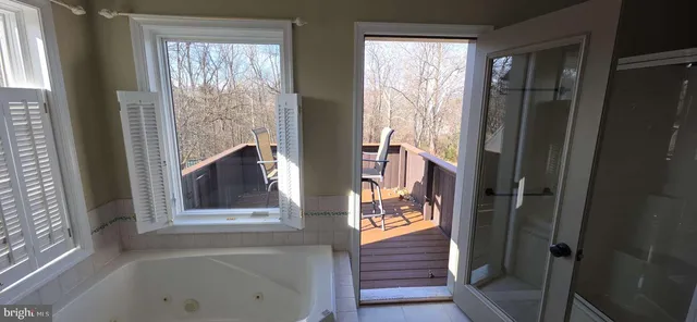 a bathroom with a tub and shower