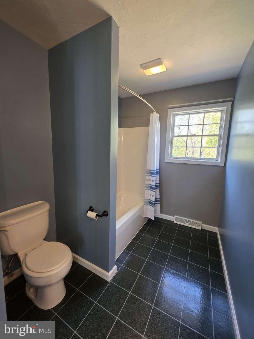 798 Menges Mills Road Spring Grove, PA 17362 - Photo 35 of 50 a bathroom with a toilet a window and a shower