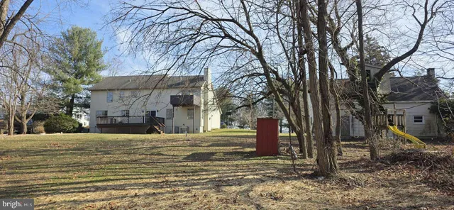 a view of a house with backyard and porch