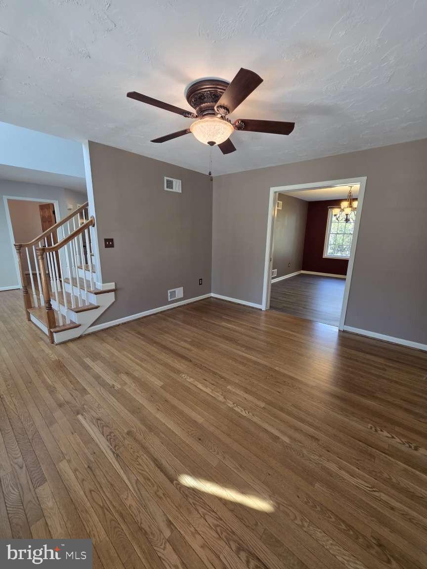 798 Menges Mills Road Spring Grove, PA 17362 - Photo 9 of 50 a view of an empty room with wooden floor and a ceiling fan