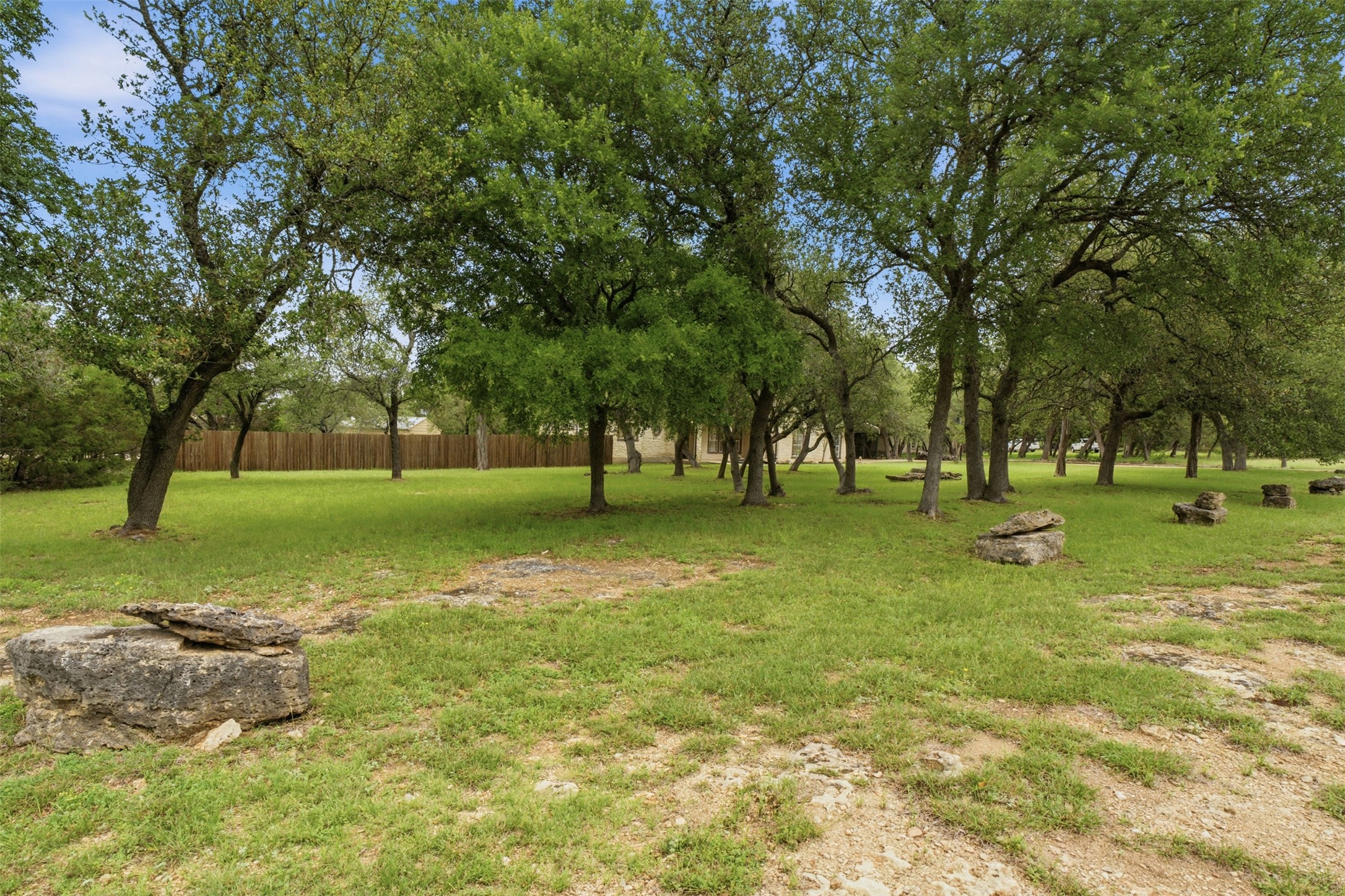 1301 County Road 262 Georgetown, TX 78633 - Photo 36 of 39 Spacious natural landscape featuring numerous mature trees, a manicured lawn, and natural rock formations