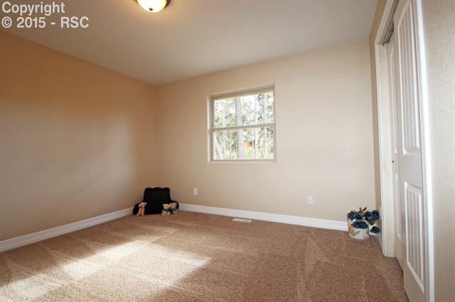 11420 Teachout Road Colorado Springs, CO 80908 - Photo 19 of 36 Bedroom three on main floor. Both bedroom two and three are across the living room from the master. Privacy if you want it, but within ear-shot.