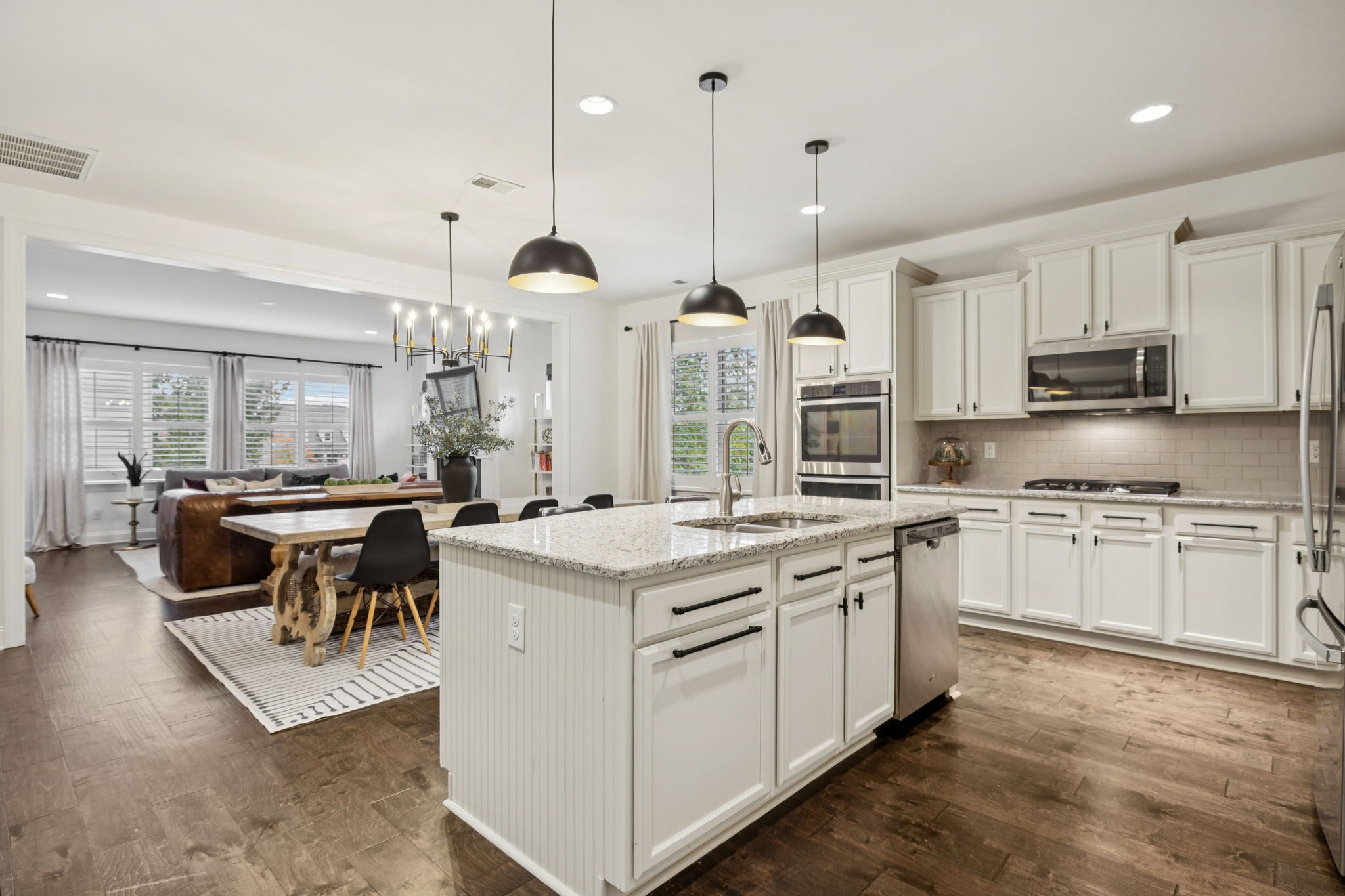 2000 Nolencrest Drive Franklin, TN 37067 - Photo 6 of 52 a kitchen with stainless steel appliances granite countertop a stove a sink dishwasher a refrigerator and a dining table with wooden floor