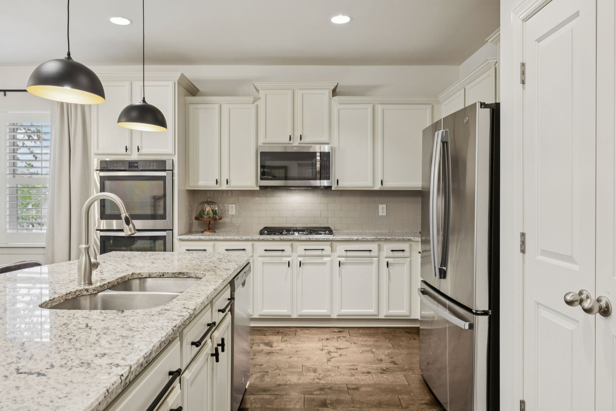 2000 Nolencrest Drive Franklin, TN 37067 - Photo 7 of 52 a kitchen with stainless steel appliances granite countertop a sink a stove a refrigerator and a granite counter tops