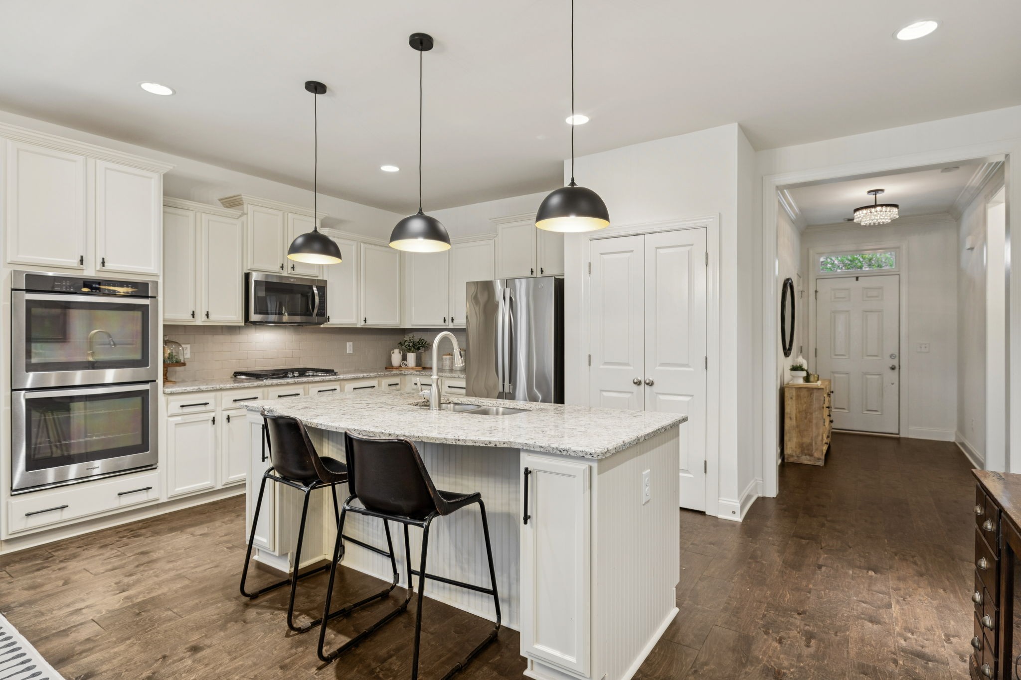 2000 Nolencrest Drive Franklin, TN 37067 - Photo 8 of 52 a kitchen with stainless steel appliances kitchen island granite countertop a stove a sink and a wooden floor