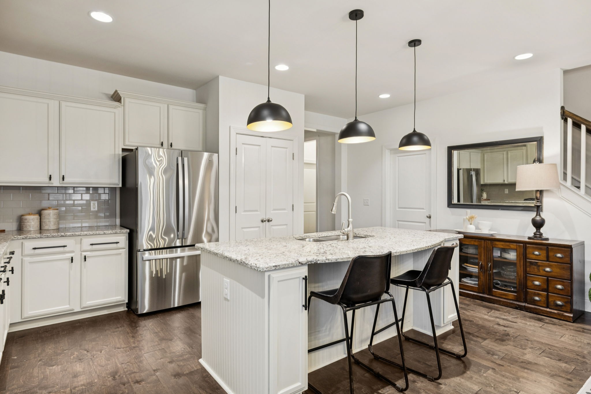 2000 Nolencrest Drive Franklin, TN 37067 - Photo 9 of 52 a kitchen with stainless steel appliances kitchen island a table chairs sink and cabinets