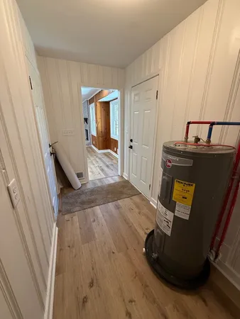 a view of a hallway with wooden floor