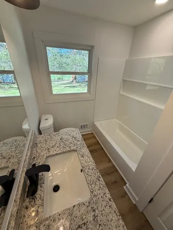 a bath tub sitting next to a window