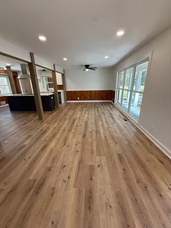 a view of empty room with wooden floor