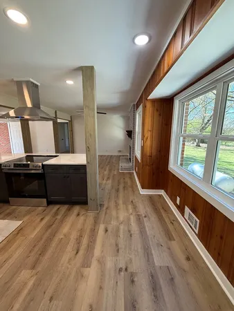 a view of kitchen with a sink and wooden floor