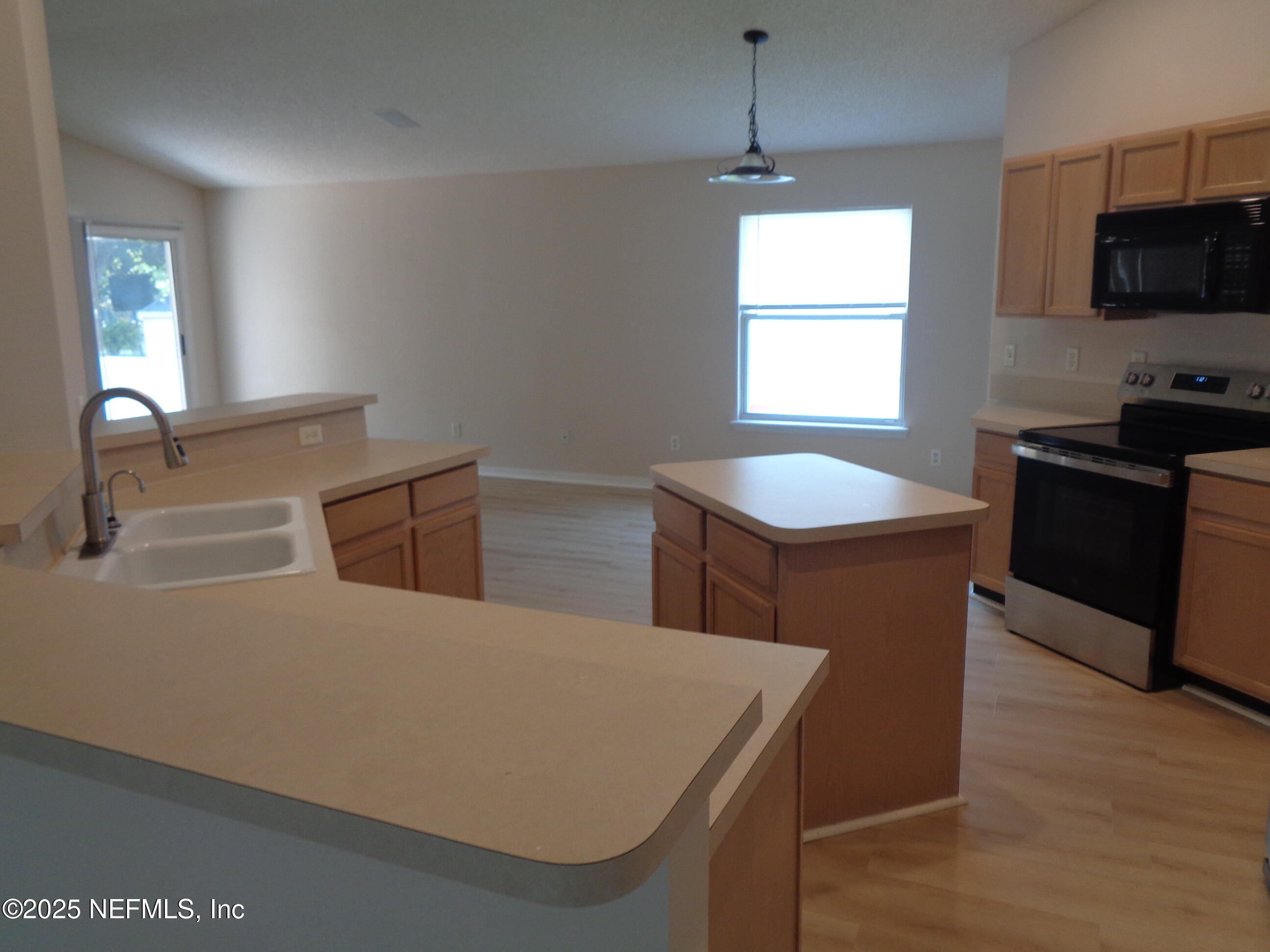 153 Dover Bluff Drive Orange Park, FL 32073 - Photo 5 of 18 a kitchen with a stove a sink and a refrigerator