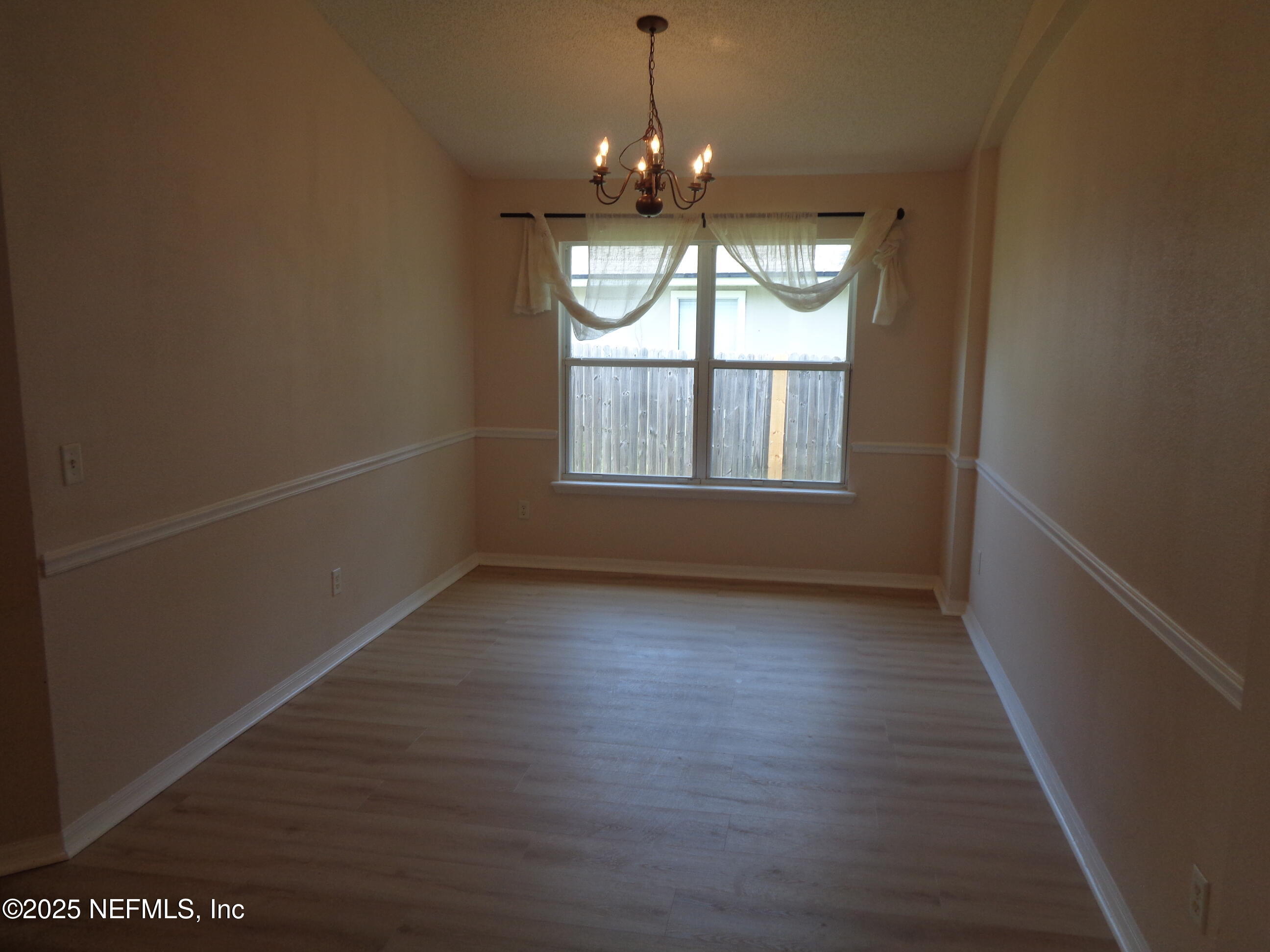 153 Dover Bluff Drive Orange Park, FL 32073 - Photo 8 of 18 an empty room with wooden floor and windows