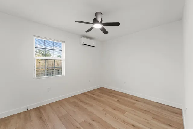 wooden floor in an empty room with a window