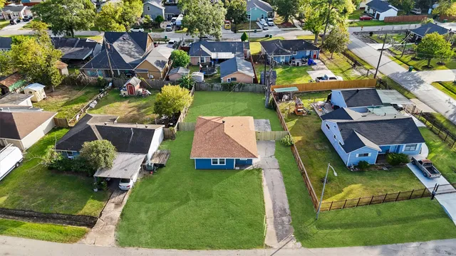 an aerial view of multiple houses with yard