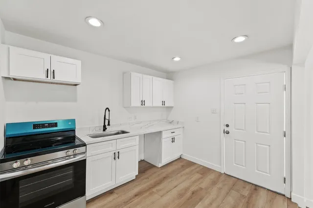 a kitchen with a sink stove and cabinets