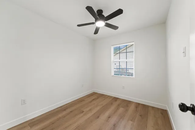 wooden floor in an empty room with a window