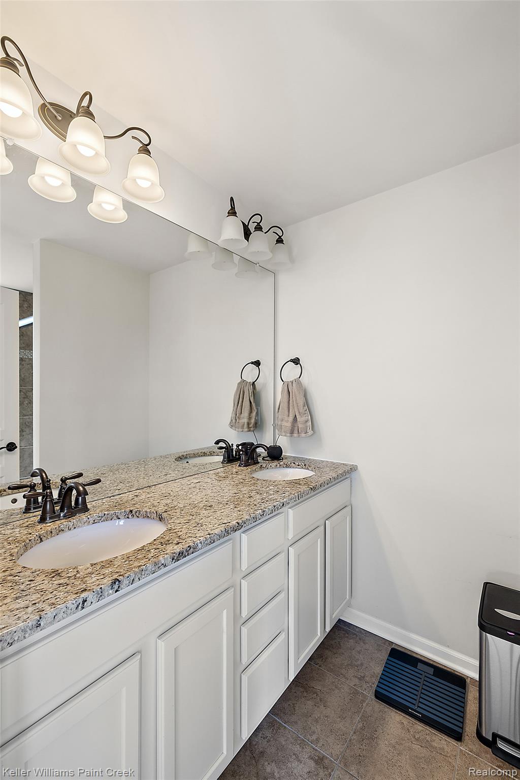 314 Glenhurst Boulevard Rochester, MI 48307 - Photo 25 of 64 Full bath featuring double vanity and dark tile patterned floors