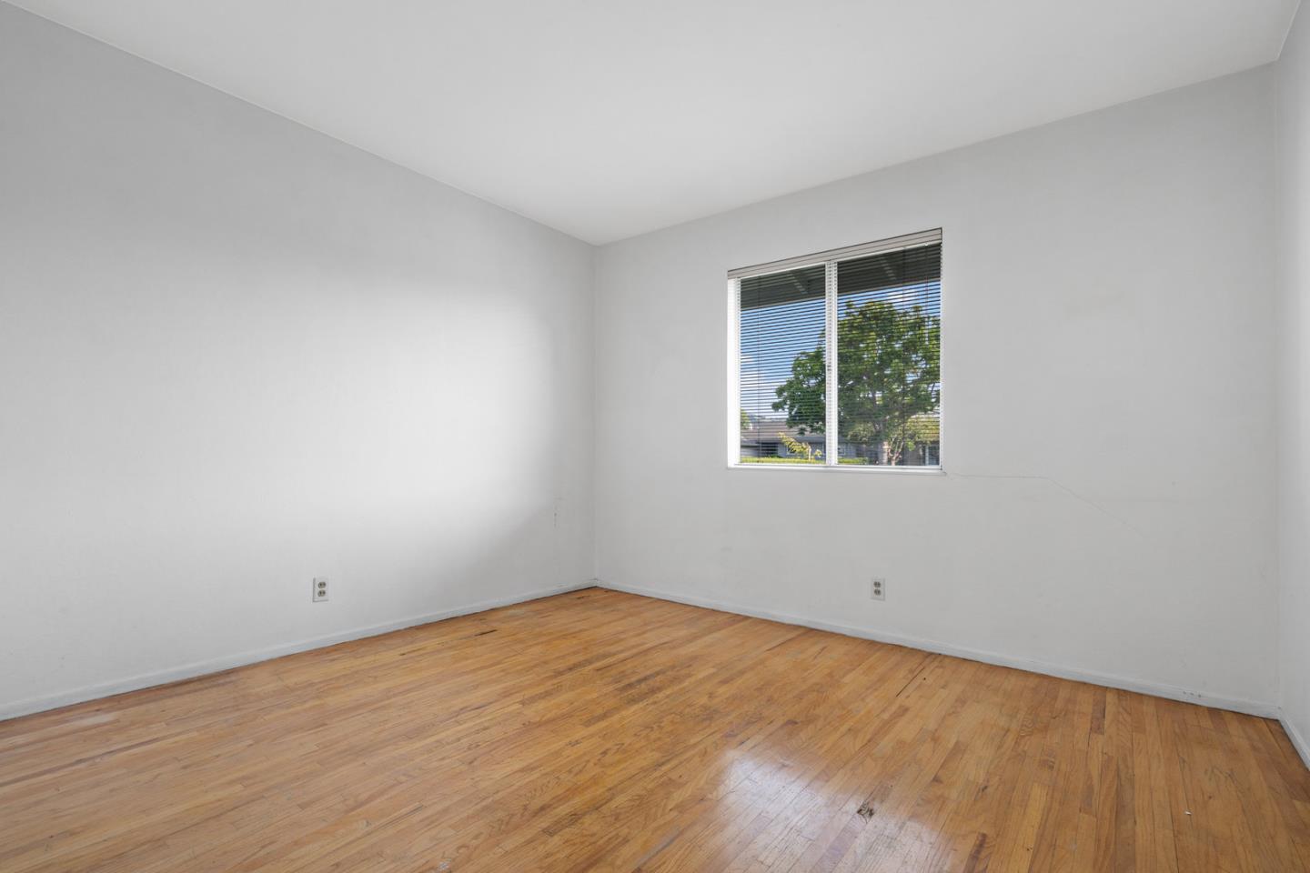 503 Paiute Lane San Jose, CA 95123 - Photo 10 of 18 a view of an empty room with wooden floor and a window