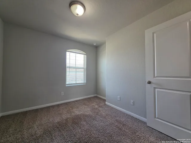 an empty room with closet area
