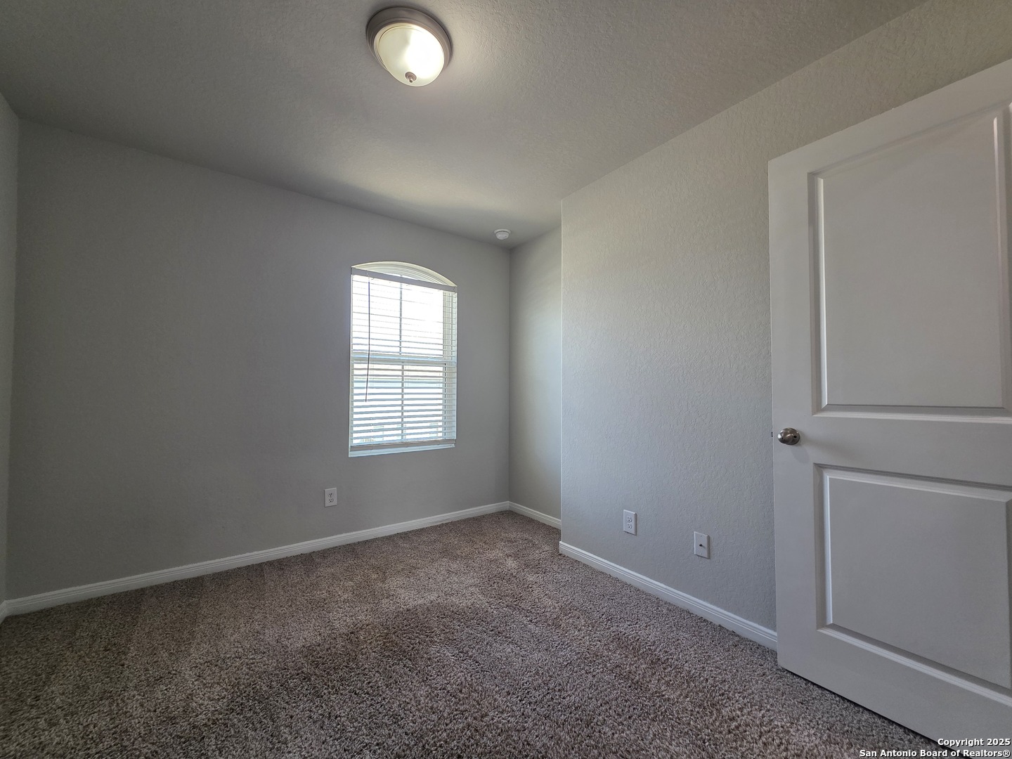 8410 Flicka Hills, Unit 2 Selma, TX 78154 - Photo 15 of 19 an empty room with windows and closet