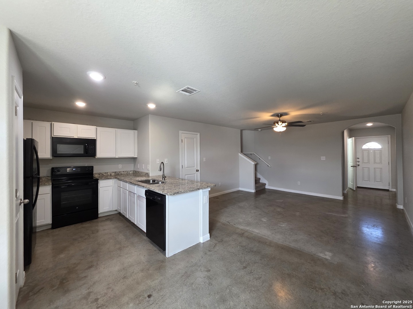 8410 Flicka Hills, Unit 2 Selma, TX 78154 - Photo 3 of 19 a kitchen with stainless steel appliances kitchen island granite countertop a refrigerator and a stove top oven