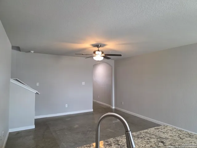 a view of a livingroom with a chandelier fan
