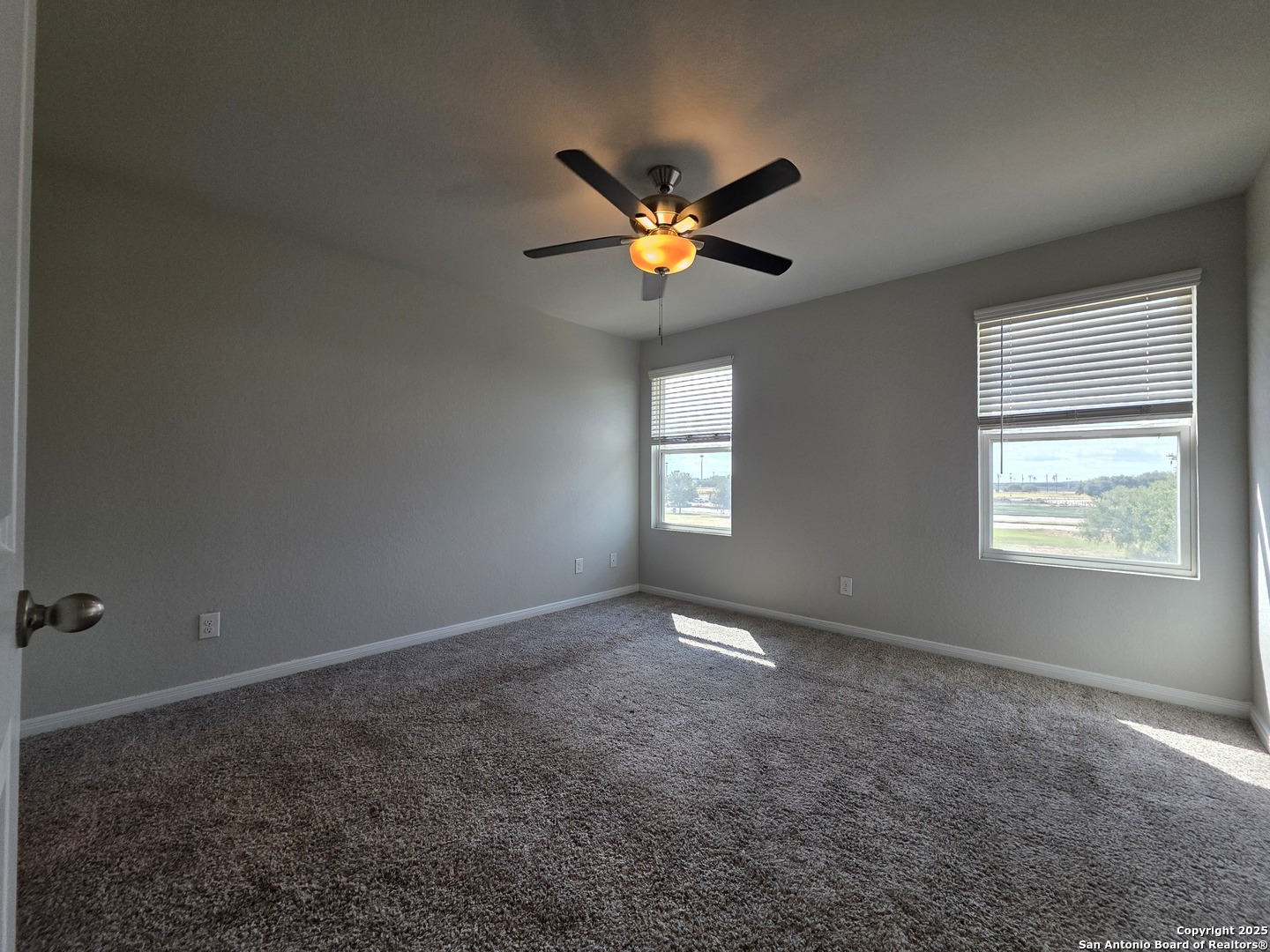 8410 Flicka Hills, Unit 2 Selma, TX 78154 - Photo 6 of 19 a view of an empty room with window and a ceiling fan
