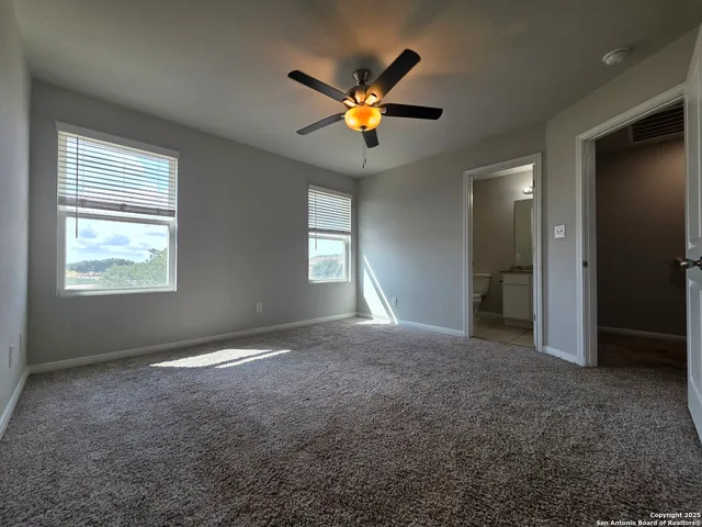 a view of a livingroom with a ceiling fan and window