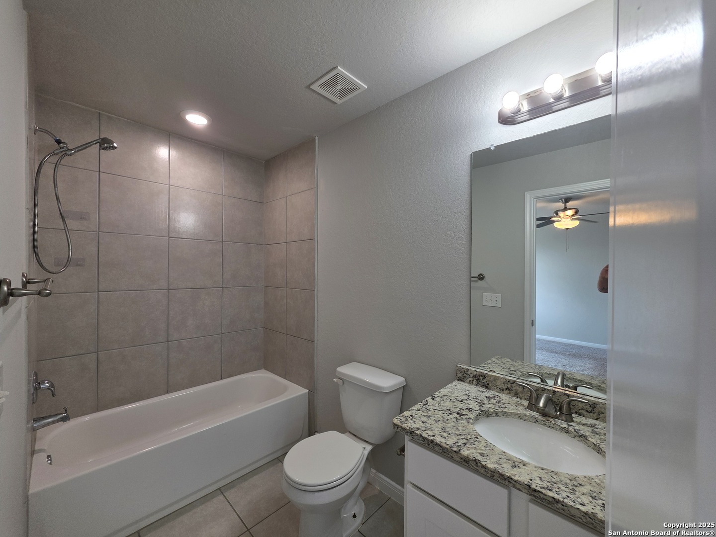 8410 Flicka Hills, Unit 2 Selma, TX 78154 - Photo 10 of 19 a bathroom with a granite countertop sink a toilet and shower