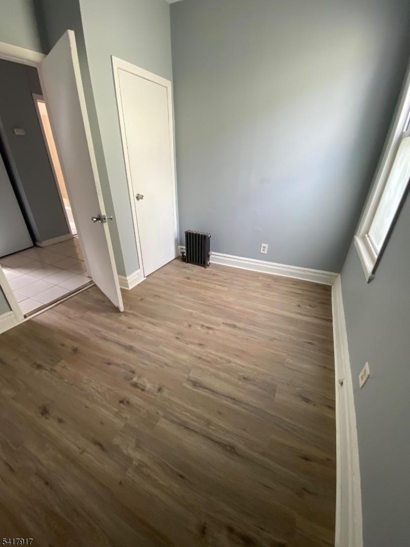 818 South 18th Street, Unit 2 Newark, NJ 07108 - Photo 11 of 12 an empty room with wooden floor and entrance