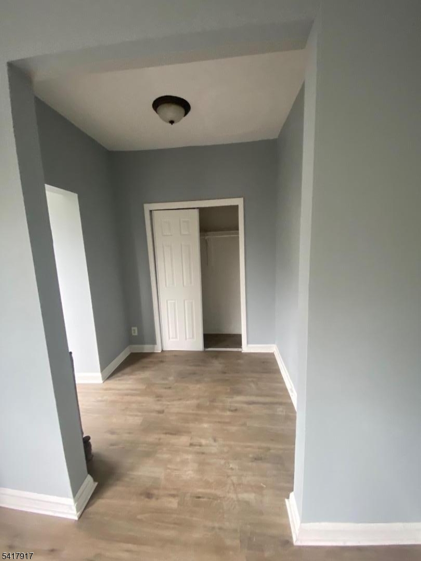 818 South 18th Street, Unit 2 Newark, NJ 07108 - Photo 3 of 12 a view of an empty room with wooden floor and a window