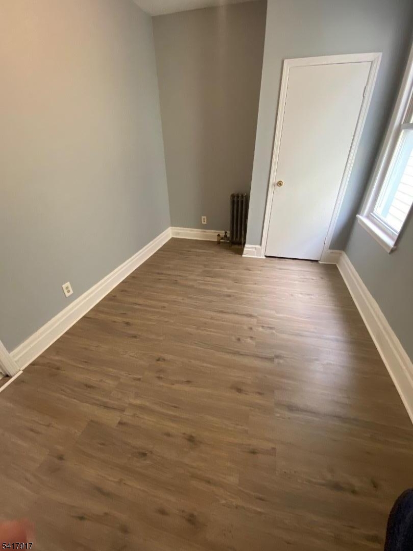 818 South 18th Street, Unit 2 Newark, NJ 07108 - Photo 10 of 12 an empty room with wooden floor and windows