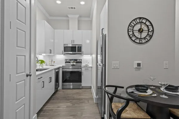 a kitchen with a stove a refrigerator and a sink