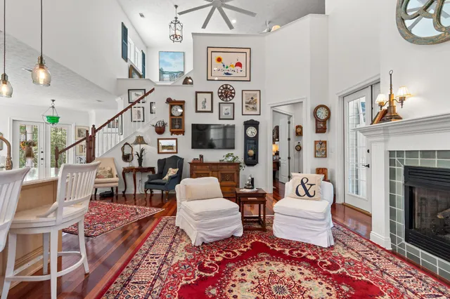 a living room with furniture a rug and a fireplace