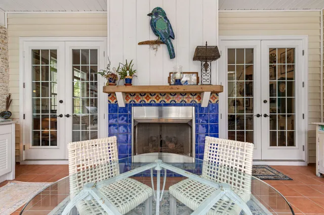 a view of a patio with dining table and chairs under an umbrella