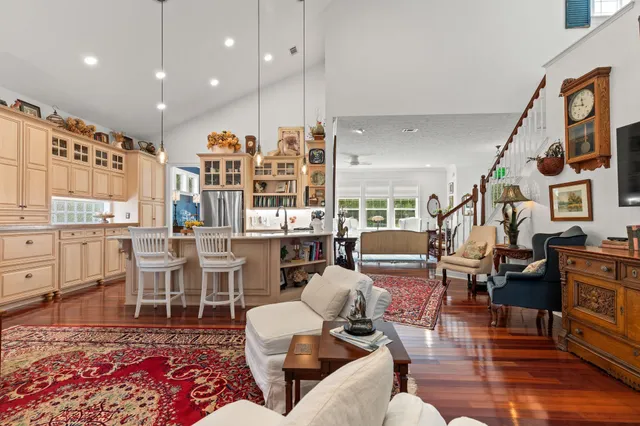 a spacious bedroom with a bed a couch and large window