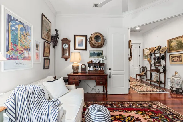 a living room with furniture and a book shelf