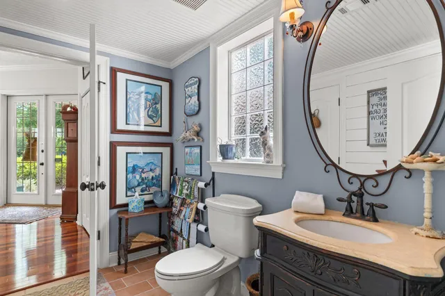 a living room with furniture a bookshelf and a flat screen tv