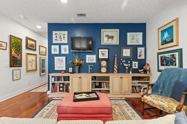 an aerial view of residential houses with outdoor space and trees