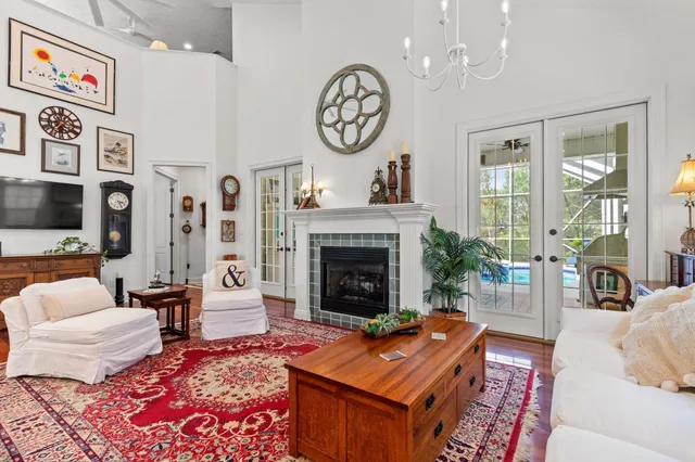 a living room with furniture a chandelier and a fireplace