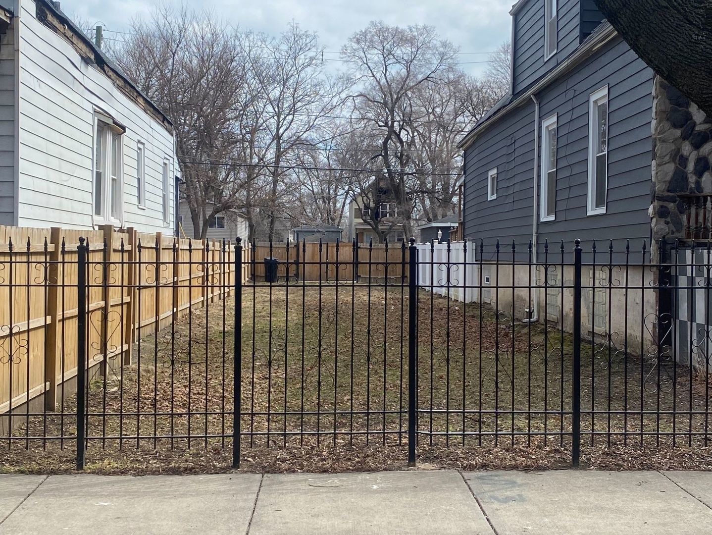 a view of a backyard with a iron fence