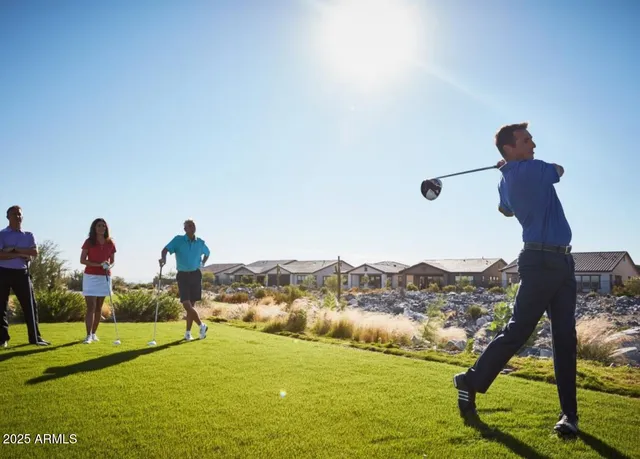 a living room with furniture a flat screen tv and a large window